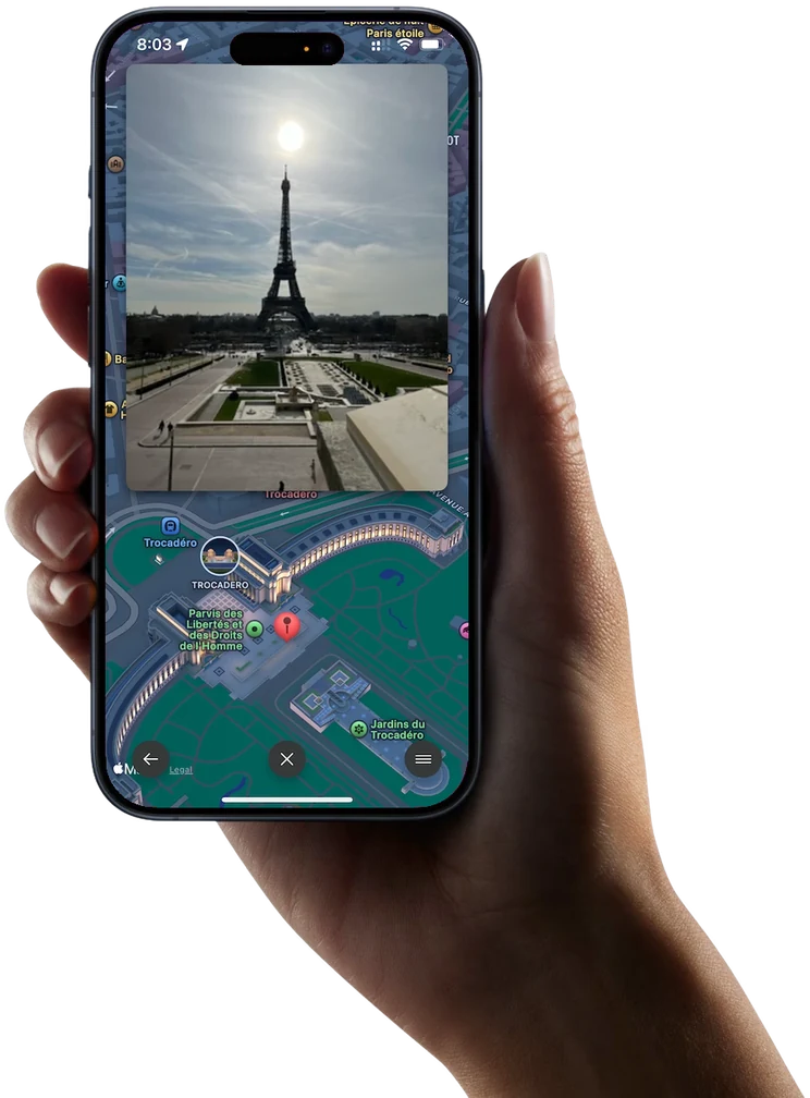Odyz on an iPhone held in a hand, showing a photo of the Eiffel Tower over the 3D map of Paris