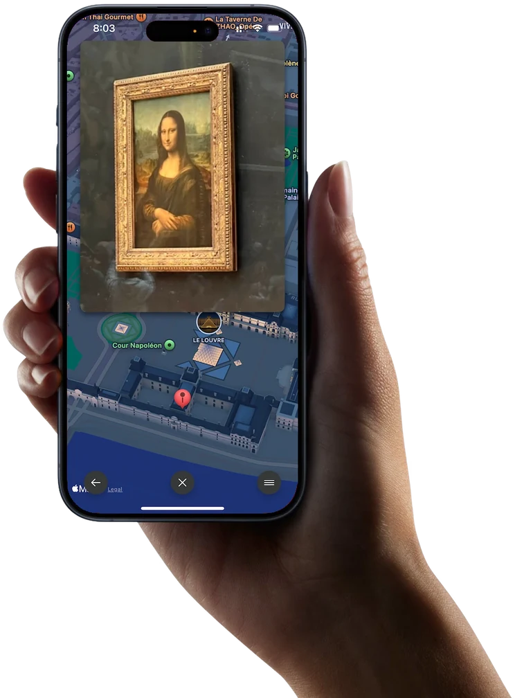 Odyz on an iPhone held in a hand, showing a photo taken inside the Louvre pinned to the map